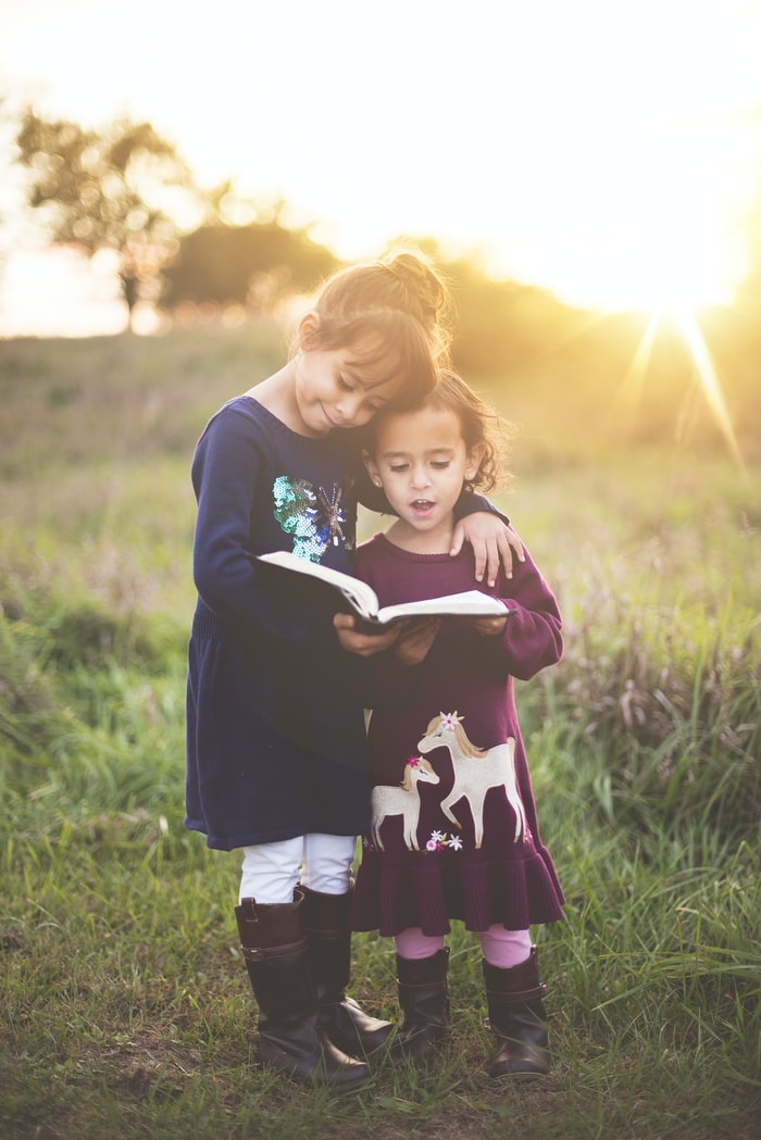 two kids reading a book